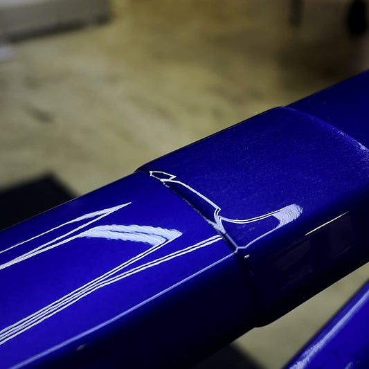 Close-up of the protection film edge over gloss frame paint